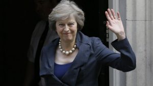 Britain's Home Secretary Theresa May waves towards the media as she arrives to attend a cabinet meeting at 10 Downing Street, in London