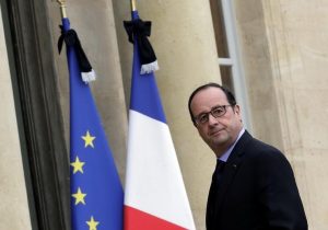 French President Francois Hollande enters the Elysee Palace in Paris