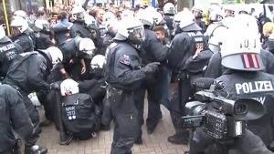 German police are shown deployed to break up a mass brawl between migrants