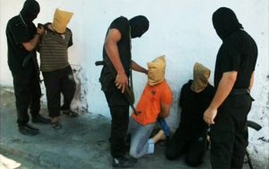 Masked Hamas members (dressed in black) prepare to execute local Palestinians who they claim spied for Israel, Aug. 22, 2014, in Gaza