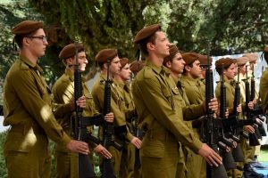 Israeli soldiers stand at attention at the state memorial ceremony marking 10 years since the Second Lebanon War at the Mount Herzl military cemetery in Jerusalem on July 19