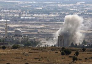 Smoke rises during fighting in the village of Ahmadiyah in Syria, as seen from the Israeli side of the border fence between Syria and the Golan Heights