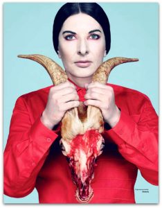 Marina Abramovic posing with a bloody goat’s head
