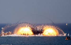 This display of military might took place on Friday in Crimea as Russia showcased its ground, marine and air forces. Pictured is an explosion from a thermobaric bomb, which create a pressure wave that can suck the air out of people's lungs The drills involved 12,500 troops, alongside fighter jets and anti-aircraft missiles, and took place at the Opuk training range on the Black Sea coast. Pictured is another view of the thermobaric bomb blast 