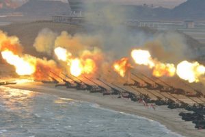 Artillery pieces are seen being fired during a military drill at an unknown location, in this undated photo released by North Korea's Korean Central News Agency 