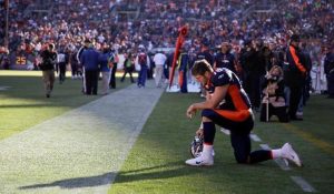 In this Dec. 11, 2011 file photo, Denver Broncos quarterback Tim Tebow prays in the end zone before the start of an NFL game against the Chicago Bears, in Denver. Peyton Manning has joined the Broncos
