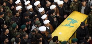 Mourners pray over the casket of Hezbollah military leader Mohammed Issa, a senior commander responsible for Hezbollah operations in Syria and Iraq, one of the six Hezbollah fighters killed in an Israeli strike near Quneitra on the Syrian-controlled side of the Golan Heights, during his funeral in the southern Lebanese village of Arab Salim on January 20, 2015. The attack on January 18 enraged Hezbollah's supporters, but analysts said the group would avoid a major escalation with Israel. AFP PHOTO/MAHMOUD ZAYYAT (Photo credit should read MAHMOUD ZAYYAT/AFP/Getty Images)