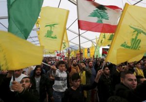 Supporters of Lebanon's Hezbollah leader Hassan Nasrallah wave Hezbollah and Lebanese flags in south Lebanon