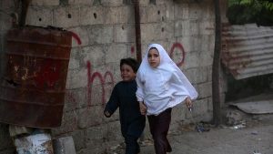 Syrian children run for cover following a reported airstrike on Kafr Batna, in the rebel-held eastern Ghouta area, on the outskirts of the capital, Damascus, on Sept. 30, 2016