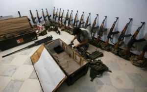 A rebel fighter of 'Al-Sultan Murad' brigade arranges weapons inside a warehouse in the northern Syrian rebel-controlled town of al-Rai, in Aleppo Governorate, Syria, September 26, 2016